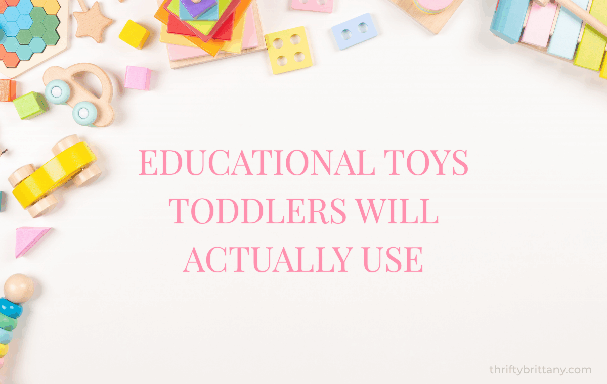 Pink flat lay of educational toys for toddlers. Christmas and birthday gift ideas including wooden toys, magnetic tiles, stacking stones, balance bike, and Montessori toys.