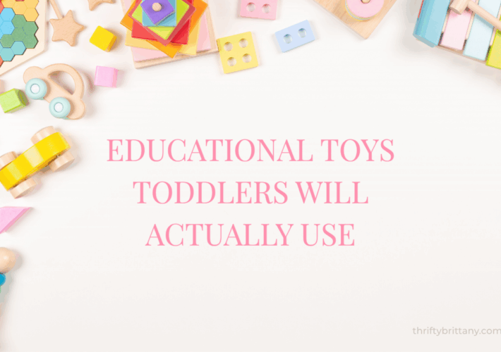 Pink flat lay of educational toys for toddlers. Christmas and birthday gift ideas including wooden toys, magnetic tiles, stacking stones, balance bike, and Montessori toys.